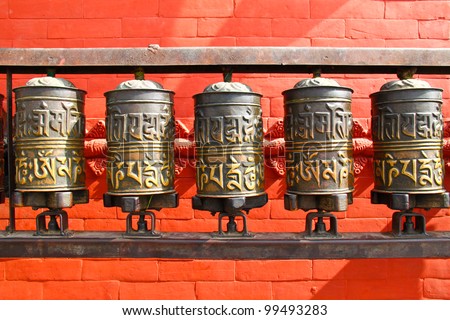 stock-photo-buddhist-prayer-wheels-nepal-99493283.jpg