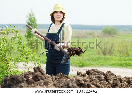 stock-photo-female-farmer-spreads-manure-at-field-103522442.jpg