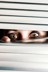scared-woman-in-blinds-200x300.jpg