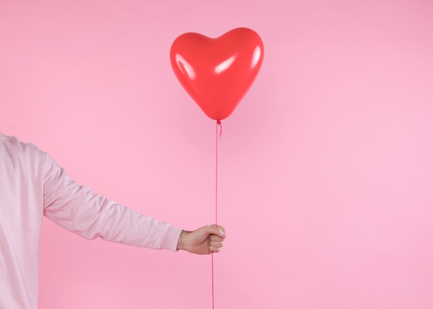 person-holding-red-balloon-with-twist_23-2148012077.jpg