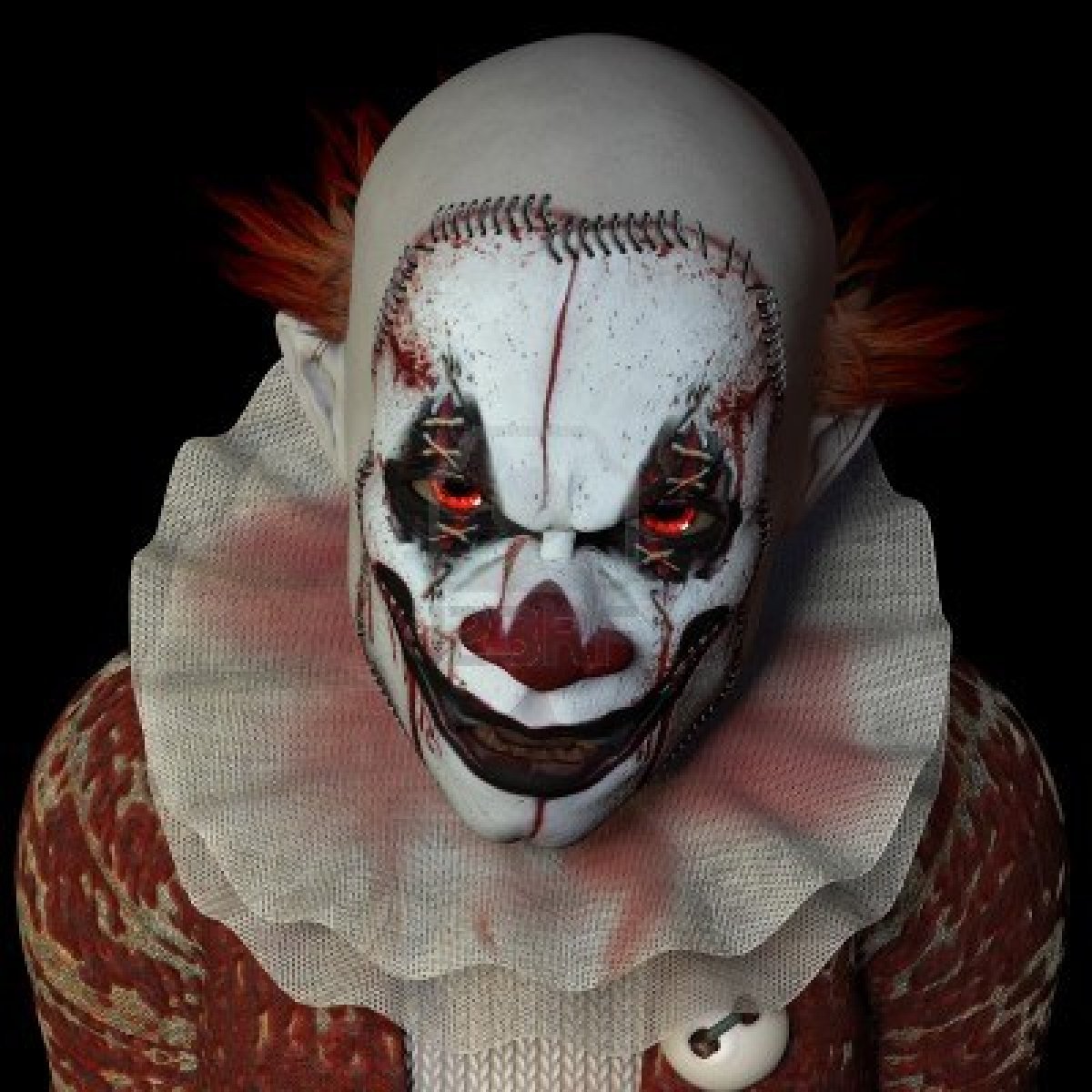 15889856-scary-clown-glaring-at-you-isolated-on-a-black-background.jpg