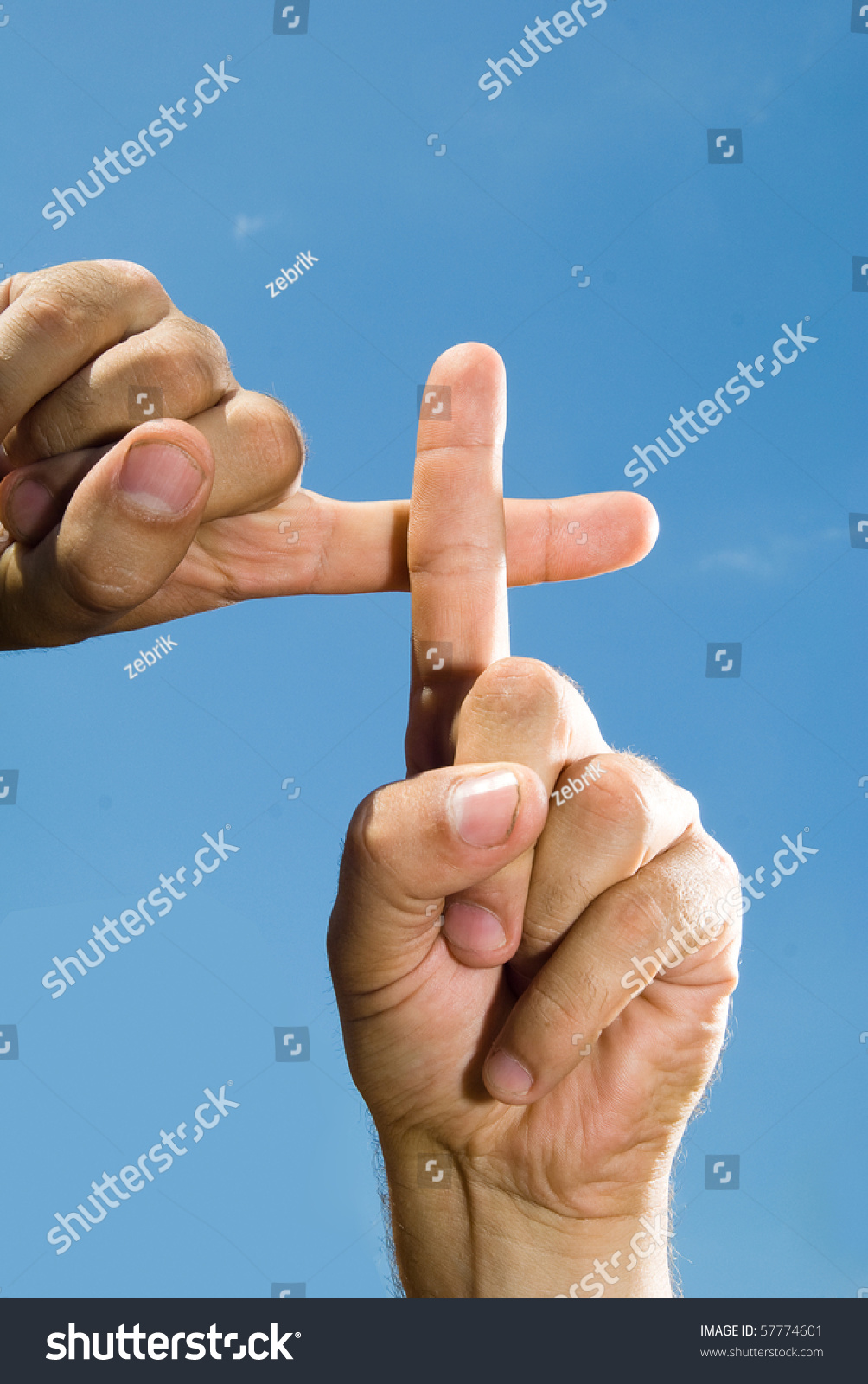 stock-photo-photo-of-hands-fingers-that-form-a-cross-against-the-blue-sky-57774601.jpg