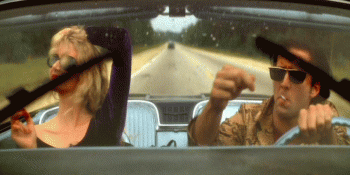 Nicholas-Cage-Laura-Dern-Wild-At-Heart-Dance-While-Driving-a-Car.gif