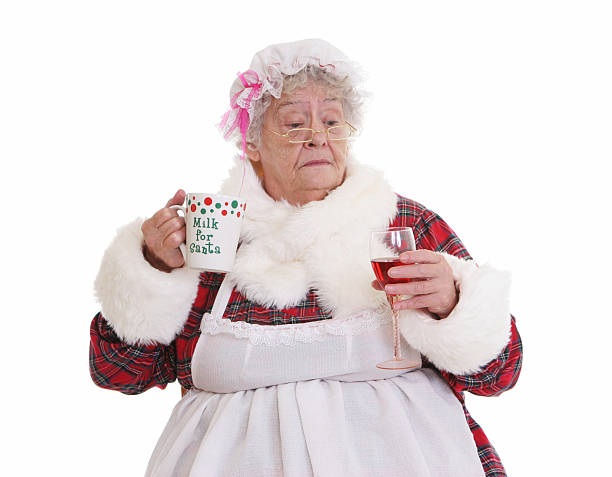 christmas-senior-mrs-claus-holding-milk-and-wine-picture-id183348913