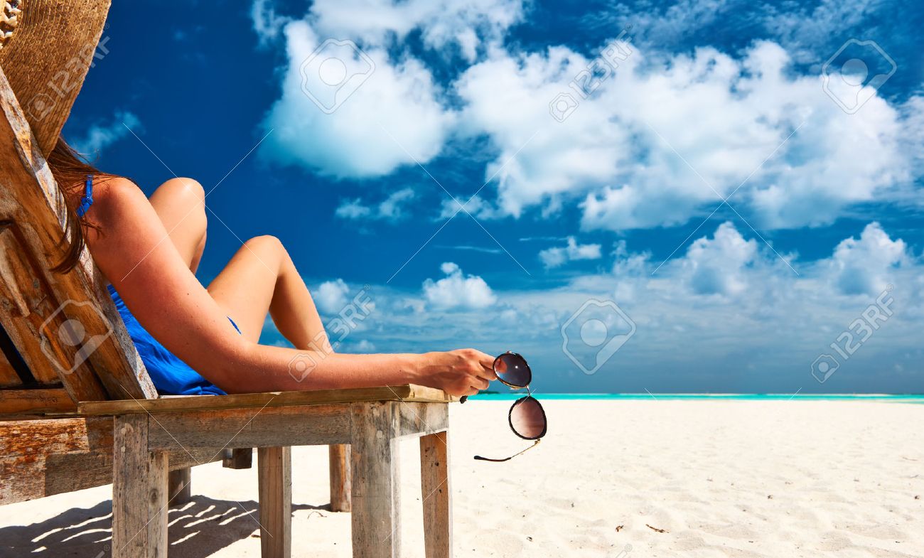 39444070-woman-at-beautiful-beach-holding-sunglasses.jpg